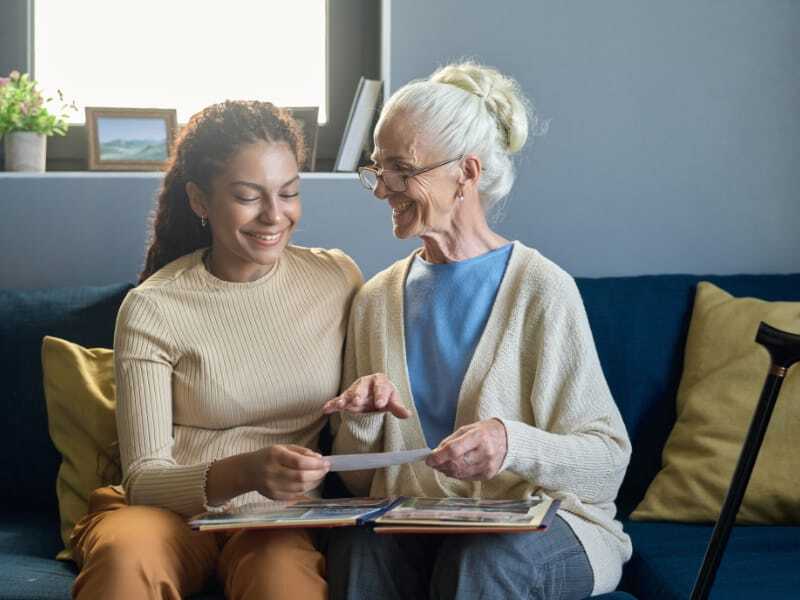 caregiver and resident looking at pictures